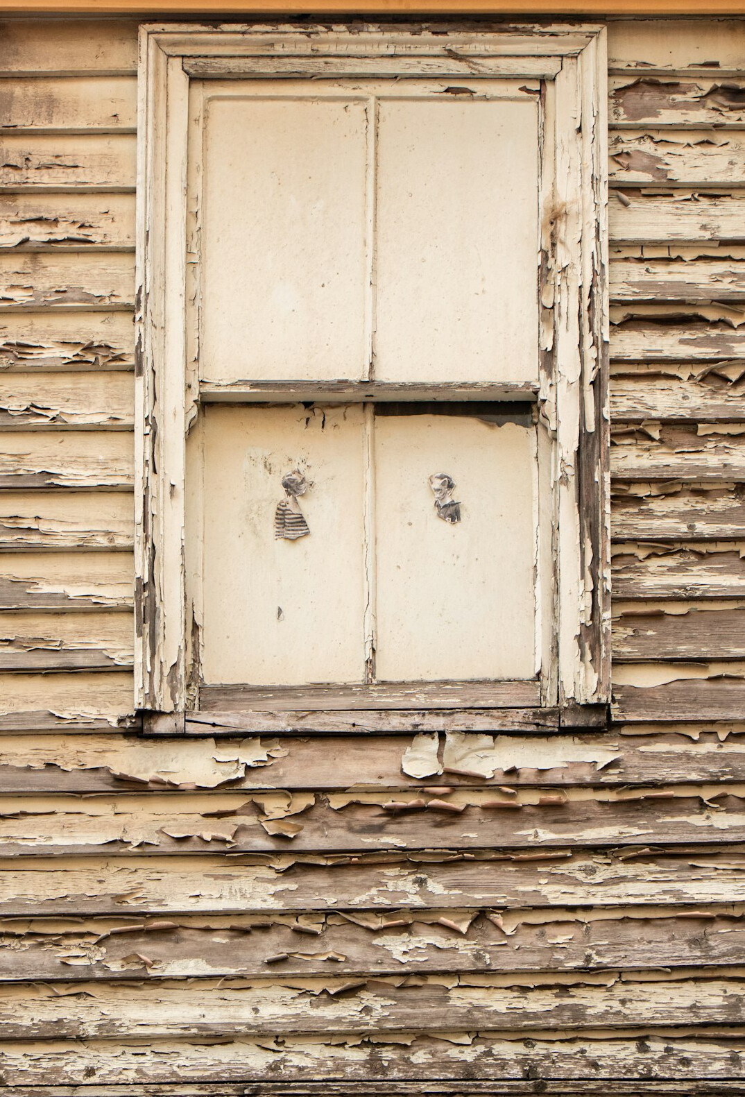 Close-up of a weathered wooden window on an old Chilean building