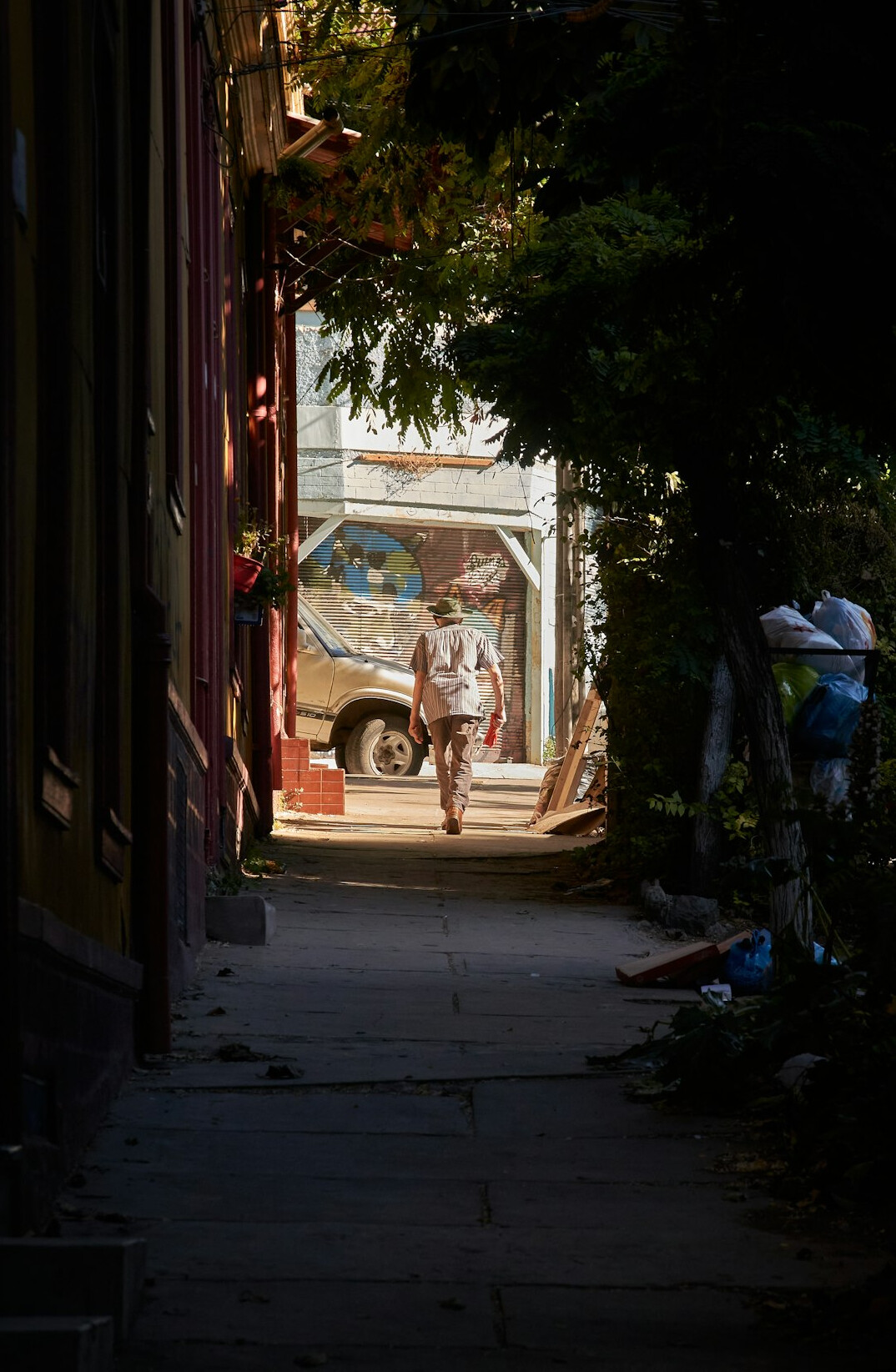 Neighbors talking in a narrow street of an old Chilean neighborhood