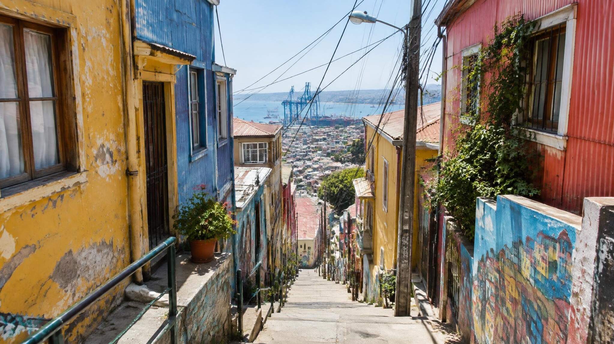 Steep stairway alley between colorful buildings in Valparaíso