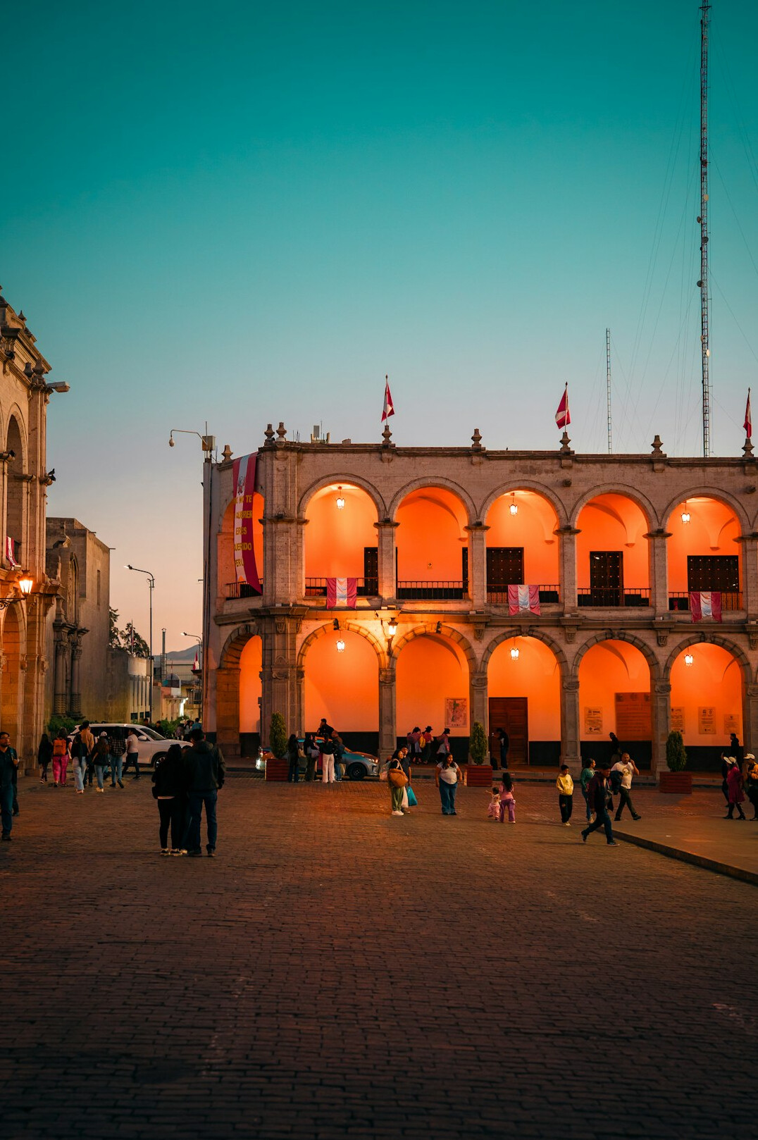 Chilean night watchman standing outside an old building at dusk